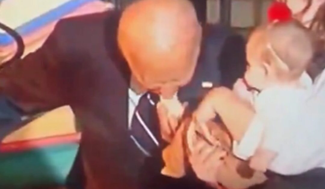 SECOND VICTIM: Biden Puts Baby’s Entire Foot IN HIS MOUTH After Biting Another Baby at Halloween Celebration (VIDEO)